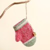 Felt red and green mitten Christmas tree hanging decoration suspended from a branch