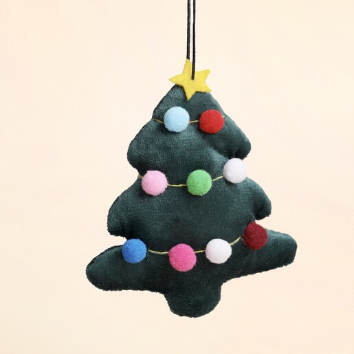 Close-up of green plush velvet Christmas tree ornament with multi-coloured mini pom poms
