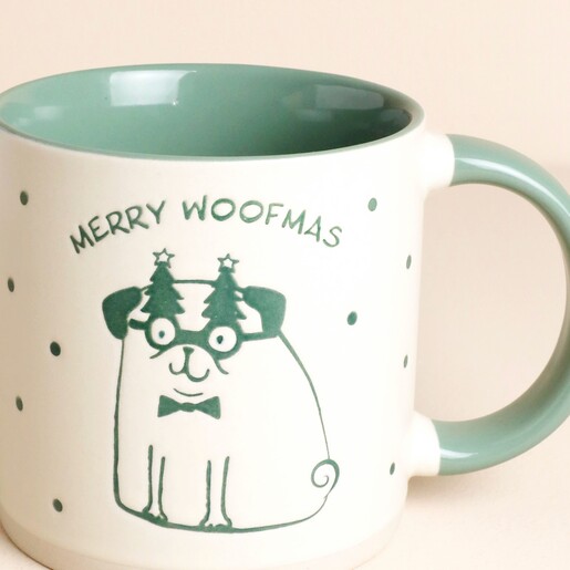 Close-up of the pug illustration on the Merry Woofmas ceramic mug