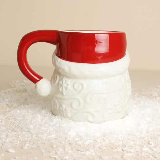 Back of ceramic Father Christmas mug showing red hat handle on white snow
