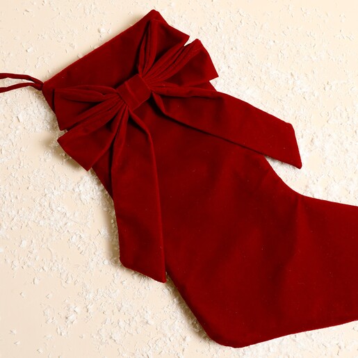 Close-up of the red velvet Christmas stocking showing oversized bow details