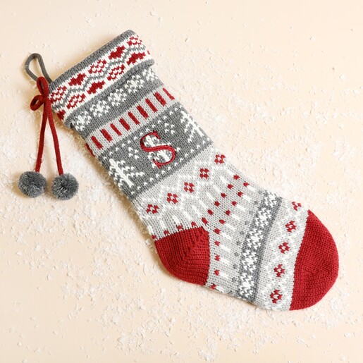 Personalised knitted grey Fairisle Christmas stocking with red embroidered initial S and pom-poms