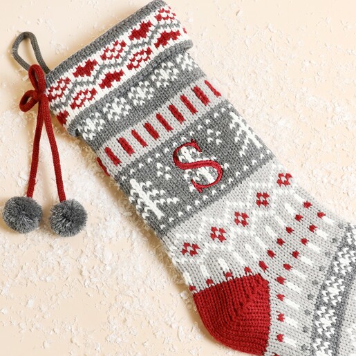 Close-up of knitted Fairisle Christmas stocking showing red embroidered initial S detail