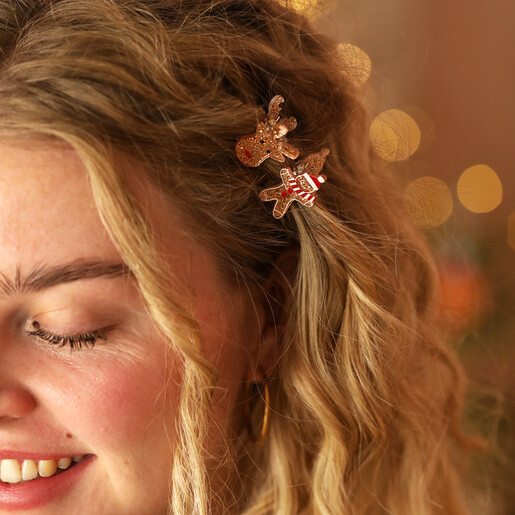 two festive hair clips in curly hair 
