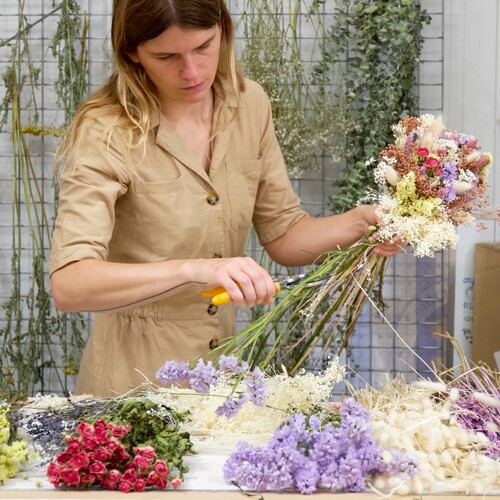 florist arranging a dried flower bouquet