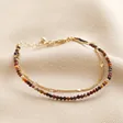 Brown Double Layer Stone Beaded Bracelet in Gold on Beige Fabric