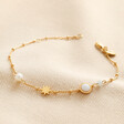 Pearl and Crystal Moon and Stars Bracelet in Gold on Beige Fabric