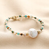 Multicoloured Crystal and Pearl Beaded Bracelet on top of neutral coloured fabric