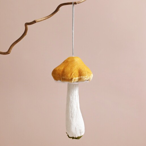 Soft Mustard Toadstool Hanging Decoration Hanging on Branch Against Pink Background