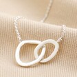 Organic Interlocking Hoops Necklace in Silver on top of beige coloured fabric