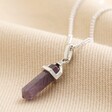 Amethyst Crystal Point Necklace in Silver on beige fabric