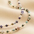Semi-Precious Stone Bead Necklace in Blue and Green with blue version on top of beige fabric