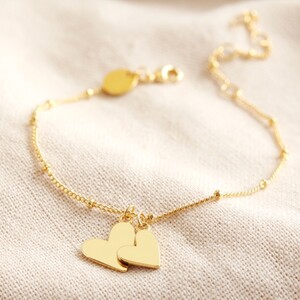 Falling Double Hearts on Satellite chain bracelet in gold plate